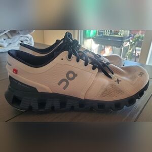 On Running Cream and Black Athletic Shoes